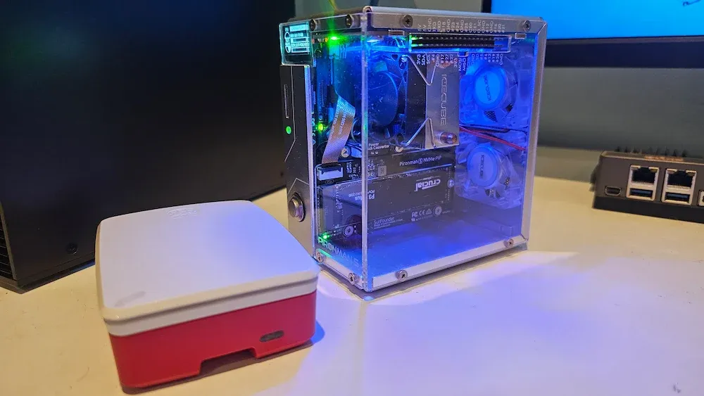 Raspberry Pi 5 official case beside Pironman 5